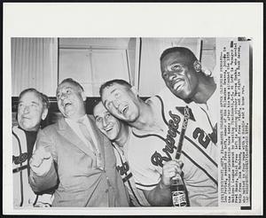 Braves Celebrate After Clinching Pennant--Lou Perini, second from left, owner of the Milwaukee Braves, joins in the clubhouse celebration here today after his team clinched the 1958 National League pennant by beating Cincinnati, 6-5. At left is Manager Fred Haney. Third from left is winning pitcher Warren Spahn, who needed help from Don McMahon, second from right, and at right is Hank Aaron, who batted in four runs with a double and a home run.
