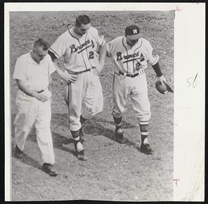 Break out the Aspirin - Milwaukee Braves outfielder Bobby Thomson is escorted from the field after being hit on the head by a pitched ball in the second inning of yesterday's game with Pittsburgh. Thomson is accompanied by Club trainer Dr. Charles Lacks, left, and Manager Fred Haney. Thomson suffered only a mild concussion.
