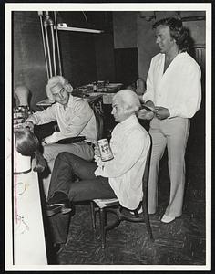 Hair Stylist Werner Sherer puts finishing touches on one of the period wigs worn in the musical "1716". Sherer left salon work to tour doing theatrical hairdressing.