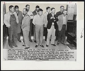 FBI Charges Ku Klux Klansmen With Flogging. Early L. Brooks(second from left,front row) exalted cyclops President of the Fair Bluff,N.C.,Klavern of the Ku Klux Klan and 9 other former klansmen are shown in the courthouse here today after be- charged by the FBI of flogging a white man and woman. This is the first arrest made in a series of flogging in Southeastern North Carolina recently.