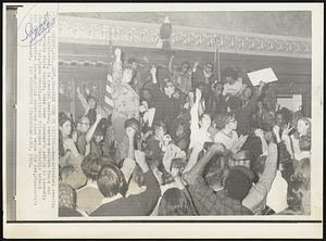 Madison, Wis. – Take Over In Capitol – Demonstrators seeking to have legislators, in special session, restore welfare funds cut from Wisconsin state budget, take over speaker’s podium in Assembly chamber. The Rev. James Groppi, militant Milwaukee Catholic priest and demonstration leader, holds upraised hand below Old Abe, Wisconsin’s Civil War mascot.