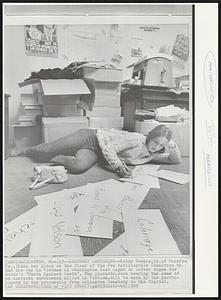 Leisurely Lettering--Kathy Teeple,16,of Fairfax, Va., finds her place on the floor of the New Mobilization Committee to End the War in Vietnam in Washington last night to letter signs for today’s “March Against Death”. The placards, each bearing the name of an American serviceman killed in Vietnam, will be worn by the participants in the procession from Arlington Cemetery to the Capitol.