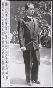Figure in woman's suit against church