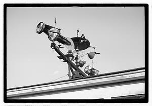An elaborate device on roof, possibly a weather vane