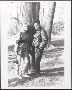 Priscilla Preston and April Postell posing against a tree
