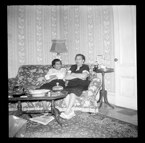 Lottie Miller and another woman are seated on a sofa