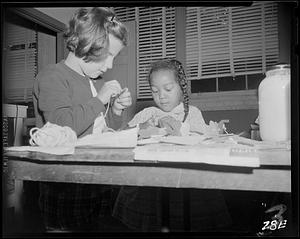 Young girls working with yarn