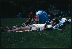 People lounging on grass in park, Cambridge, Massachusetts