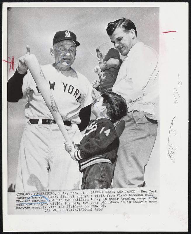 Little Moose and Casey -- New York Yankees manager Casey Stengel enjoys a visit from first baseman Bill “Moose” Skowron and his two children today at their training camp. Five year old Gregory wields the bat, two year old Steve is in daddy’s arms. Skowron reports with the fielders on Feb. 26.