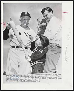 Little Moose and Casey -- New York Yankees manager Casey Stengel enjoys a visit from first baseman Bill “Moose” Skowron and his two children today at their training camp. Five year old Gregory wields the bat, two year old Steve is in daddy’s arms. Skowron reports with the fielders on Feb. 26.