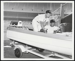 Lots Of Loot For Moose by Mick. New York, N.Y. -- Mickey Mantle (left), who is president of Love Corporation, the fiberglass boat manufacturer, presents teammate Moose Skowron with a new sportsman fiberglass boat, a little dude trailer, and a portable kitchen at The Yankee Stadium. The occasion was “Moose Skowron Day” at Yankee stadium sponsored by the Royal Order of Moose. Not bad for a day’s take.