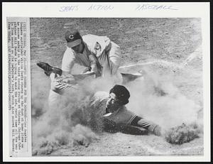 Davis Scores for the Dodgers -- Los Angeles Dodgers outfielder Willie Davis churns up the dust at home plate as he scores safely in the third inning Friday at Chicago. Chicago Cubs pitcher Bill Hands is trying to make the out. Davis came all the way in from second on Jim Lefebvre's bunt, which also scored Bill Buckner from third.