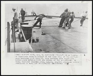 Hurricane Precautions - Mindful of Hurricane Hazel's effect on the huge hull of the battleship Kentucky last Oct. 15, dock workers here today ran extra lines between pier and vessel at the waterfront. In Hazel Kentucky snapped steel cables, drifted upstream before imbedding in mud.