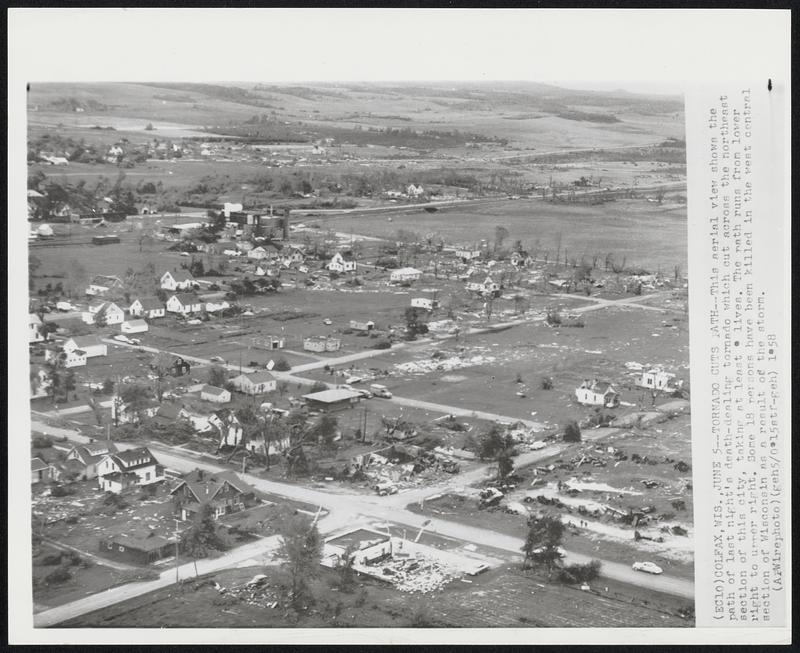 Tornado Cuts Path--This aerial view shows the path of last night's death-dealing tornado which cut across the northeast section of this city, taking at least 9 lives. The path runs from lower right to upper right. Some 18 persons have been killed in the west central section of Wisconsin as a result of the storm.