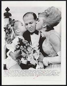 Mia Susan Kovacs, 5, (L) and her mother, Edie Adams, widow of the late comedian Ernie Kovacs, kiss New York music publisher Marty Mills after his marriage to Miss Adams in a civil ceremony here 6. Among the movie personalities attending the ceremony were Jack Lemmon and e Felicia Farr, Susan Oliver, and director Vincente Minelli. Miss Adams was owed two years ago when Kovacs was killed in an auto accident.