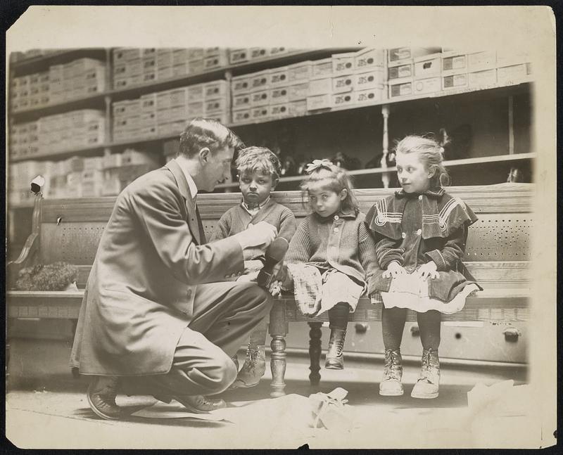 Giving shoes to children of strikers at Lawrence. Left to right- Ernest [illegible], Tillee [illegible], Lillian [illegible]