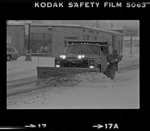 Snow plow clearing street