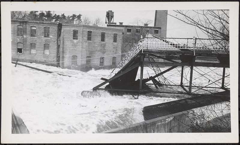 Main St. bridge being swept away by flood waters