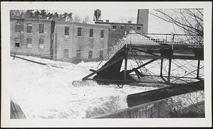 Main St. bridge being swept away by flood waters