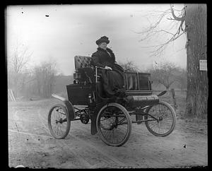 A woman in an antique car