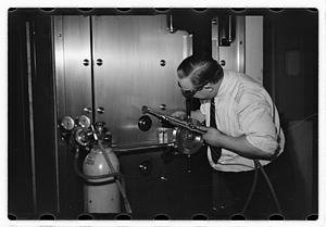 A man demonstrating how to break into a safe