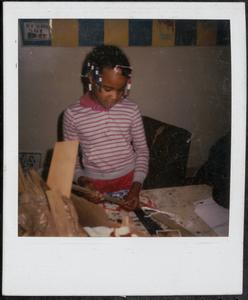 Girl in pink working on art project