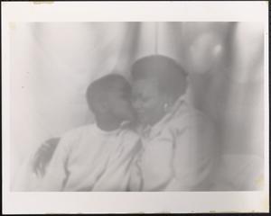 Boy kissing a woman's cheek