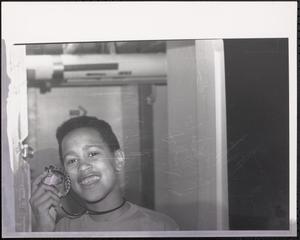 Boy smiling with necklace