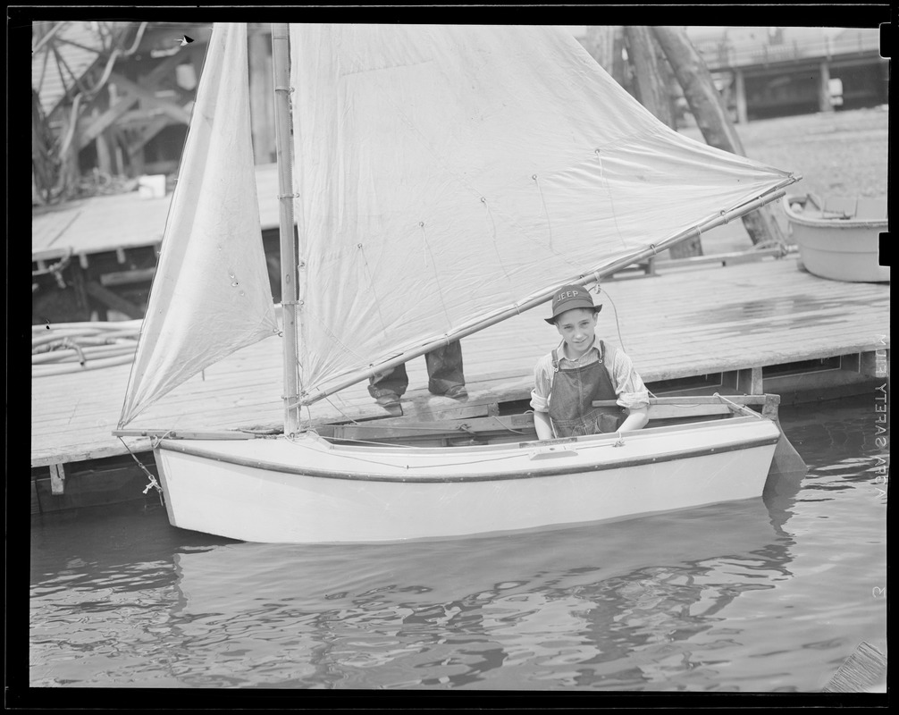 Kid in little sailboat