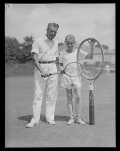 Man and boy with tennis rackets