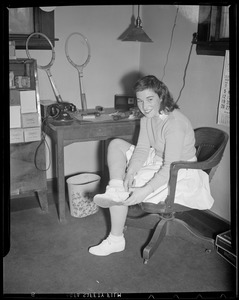 Woman player putting on her togs, at Longwood