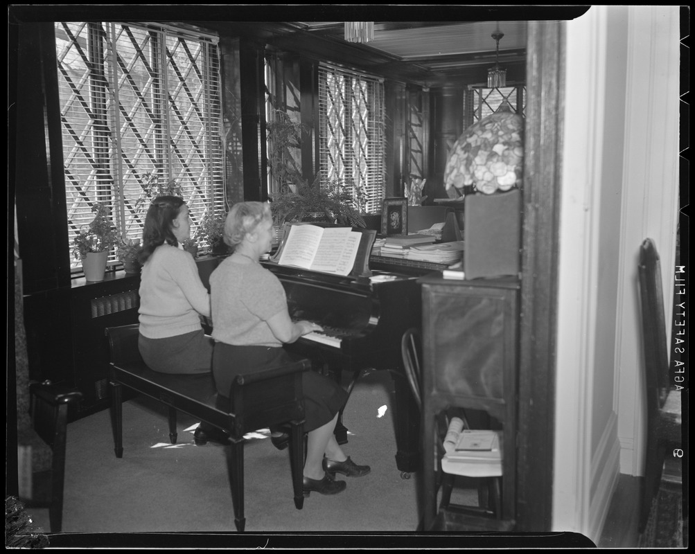 Hazel Wightman playing the piano at her home at 17 Dorothy Rd., Newton