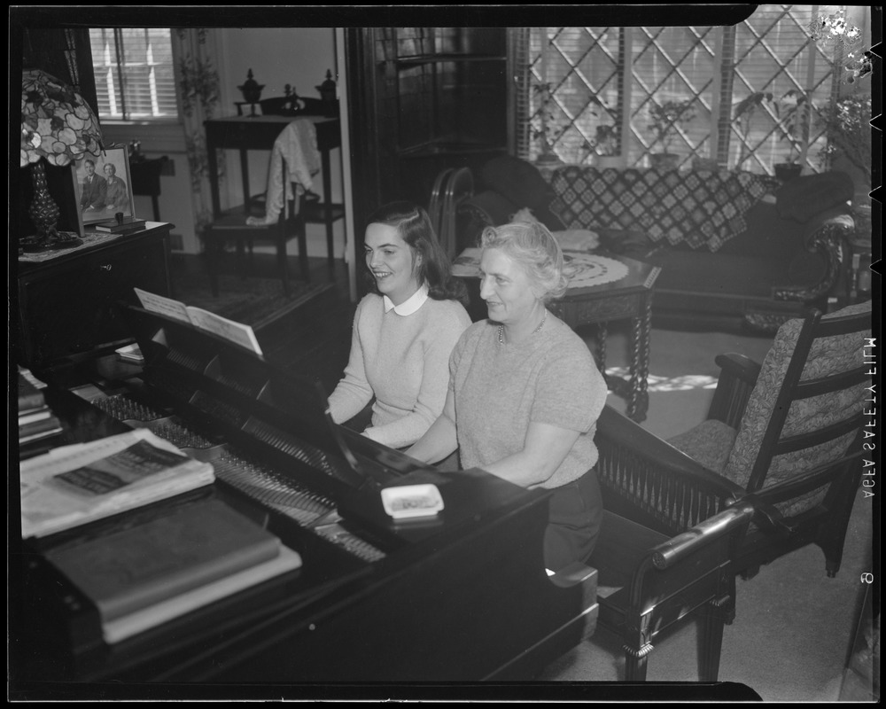 Hazel Wightman playing the piano at her home at 17 Dorothy Rd., Newton