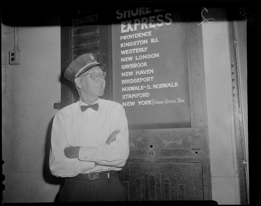 Porter stands next to Shore Line Express sign, South Station