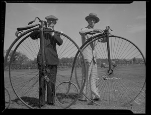 Two men with old-fashioned bicycles