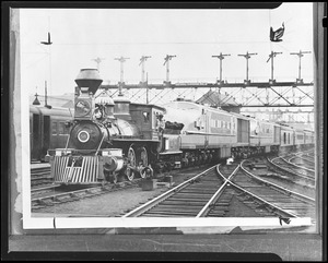 Old steam engine 58 in front of diesel locomotive and train of South Station