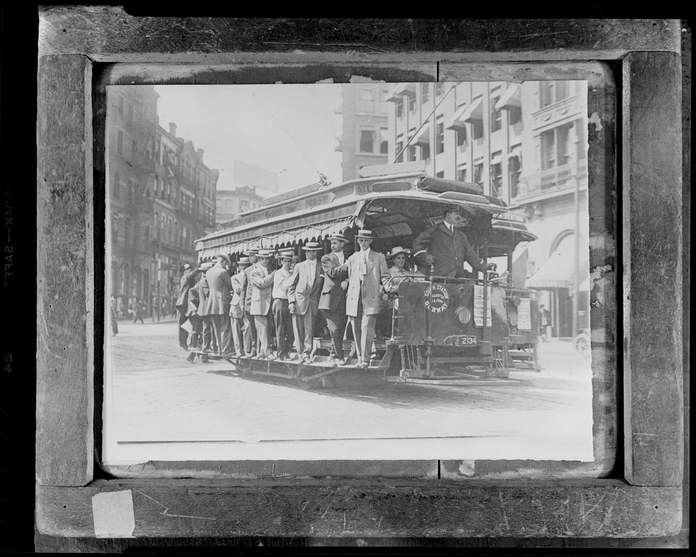Boston elevated open trolley, fully loaded, going through Scollay Square