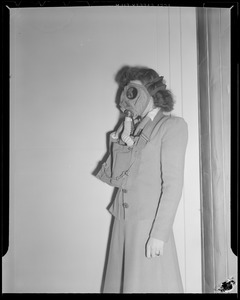 Woman in gas mask with officer, WWII