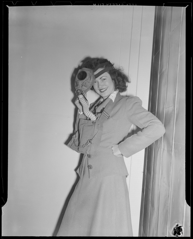 Woman in gas mask with officer, WWII