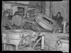 Men working on the tire for scrap, WWII