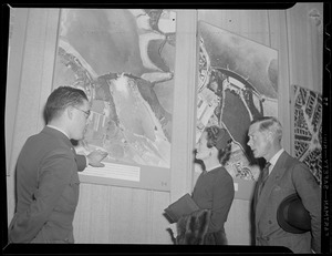 The Duke and Duchess of Windsor examine aerial photos of bomb damage to German cities, while in Boston
