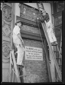 Removing bronze plaque for war drive