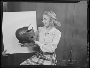 Old titling helmet given to salvage drive is held by the Traveler's Virginis Bohlin