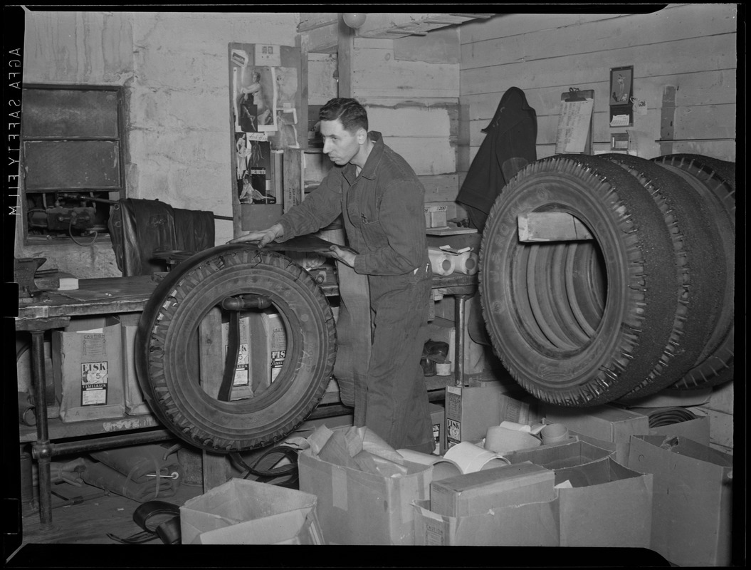 WWII: Man inspecting tires for scrap - Digital Commonwealth