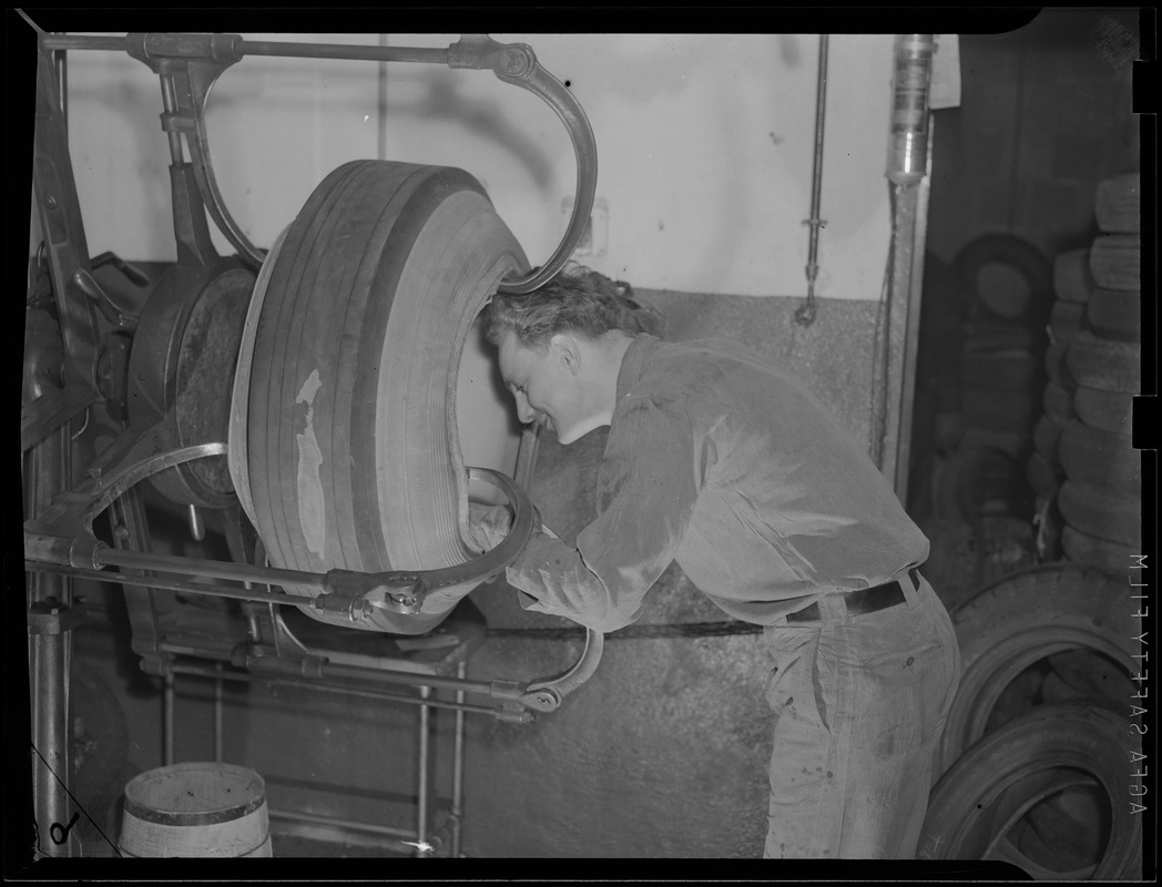 WWII: Man inspecting tires for scrap - Digital Commonwealth