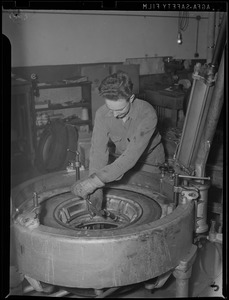 WWII: Man inspecting tires for scrap