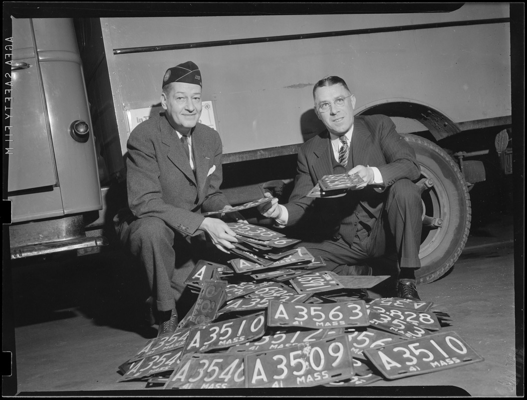 WWII: Two men with pile of licenses donated for scrap (war effort)