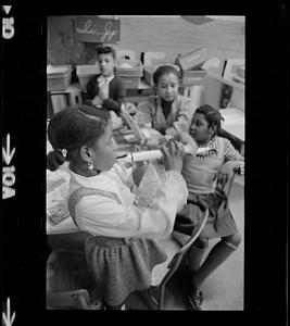Black schoolchildren play recorders, Roxbury