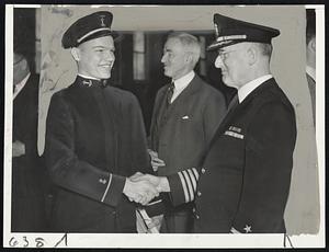 School Graduation-- N. Curtis Bliven of Malden, one of the 30 cadets graduated today from the Massachusetts Nautical School, is shown receiving the congratulations of Capt. Abele, superintendent, at exercises in the Boston navy yard drill hall.