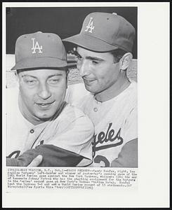 Trade Secrets--Sandy Koufax, right, Los Angeles Dodgers’ left-hander and winner of yesterday’s opening game of the 1963 World Series game against the New York Yankees, whispers into the ear of teammate Johnny Podres who has the starting assignment for the Dodgers in the Series’ second game at New York’s Yankee Stadium today. Koufax beat the Yankees 5-2 and set a World Series record of 15 strikeouts.